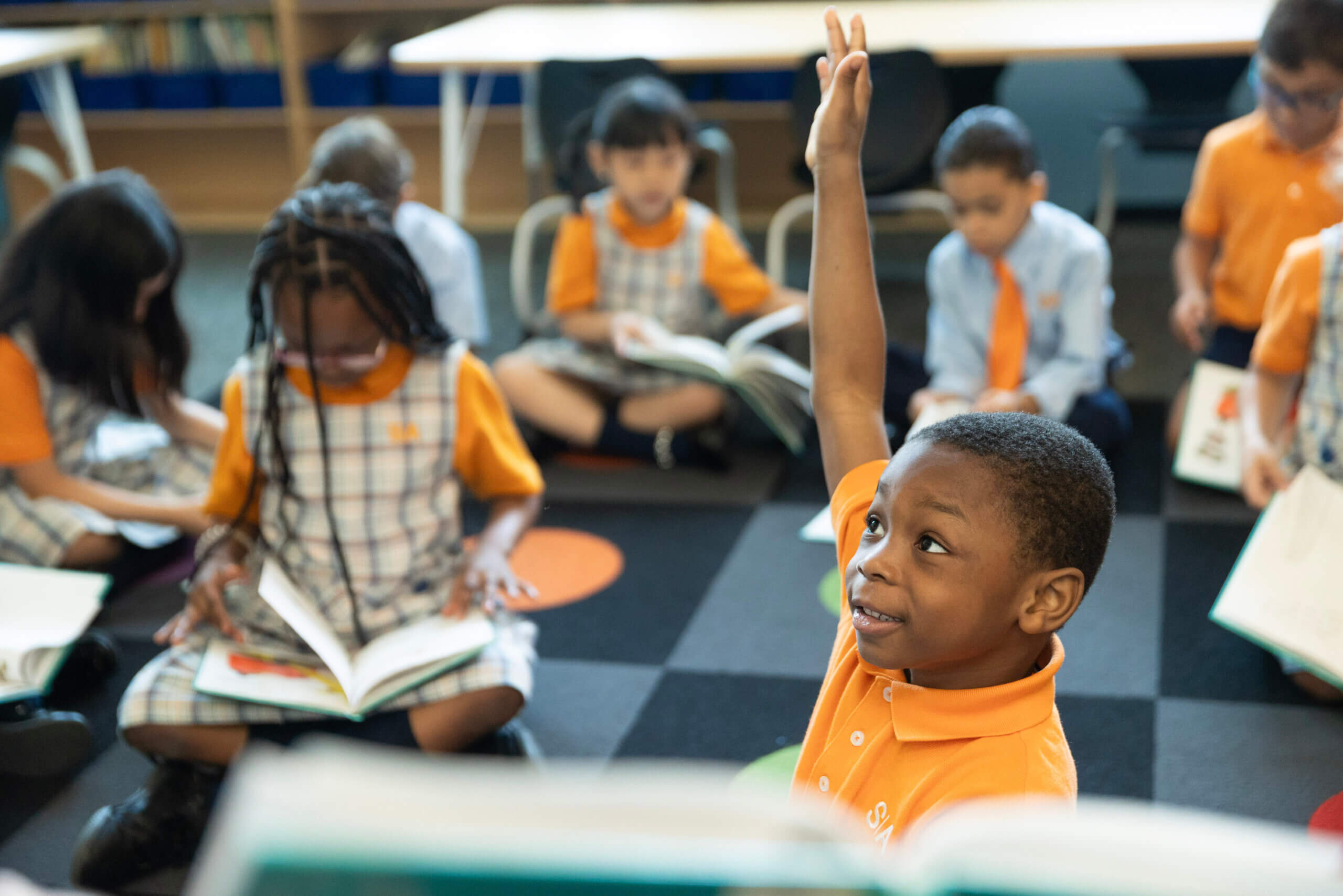 young student raising hand during a lesson