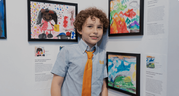 child standing in front of artwork